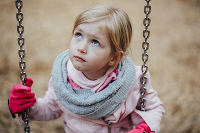 High angle view of girl on swing at park