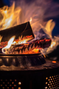 Close-up of burning fire on wood at night