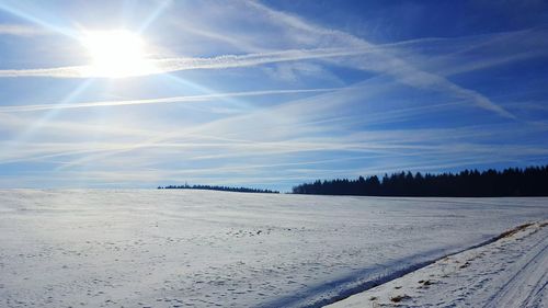 Scenic view of beach against sky during winter