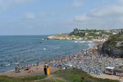 People on beach against sky
