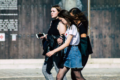 Young woman photographing while holding camera