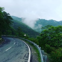 Empty road with mountains in background