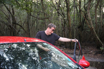 Man standing by car