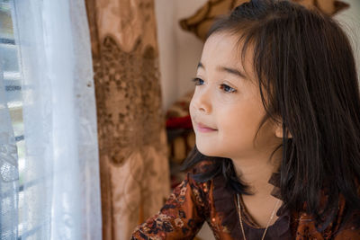 Close-up portrait of girl looking away