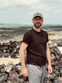 Young man standing at beach