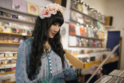 Young woman browsing albums in a record store