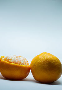 Close-up of orange fruit against white background