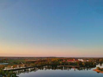 Scenic view of river against clear blue sky