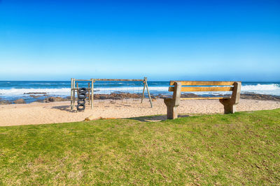 Scenic view of beach against blue sky