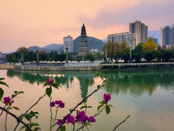 Scenic view of lake against sky at sunset