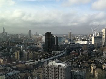 High angle view of cityscape against cloudy sky