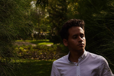 Thoughtful young man in park