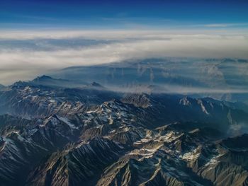 Aerial view of mountains against sky during winter