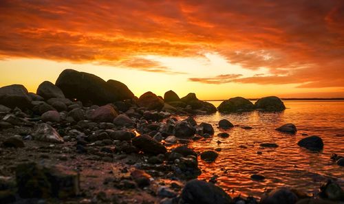 Scenic view of sea against orange sky