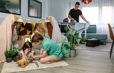 Rear view of friends and woman on floor