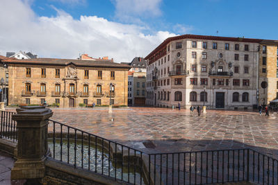 Buildings in city against sky