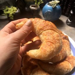 Close-up of hand holding bread on table