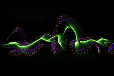 Multi colored light painting against black background
