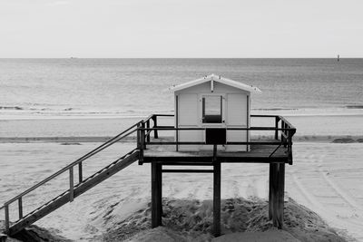 Lifeguard hut on beach against clear sky