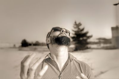 Portrait of young man against sky