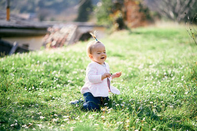 Full length of cute baby girl on field