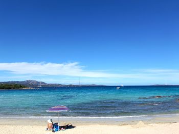 Scenic view of beach against blue sky