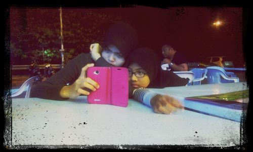 Close-up of boy photographing with mobile phone at home