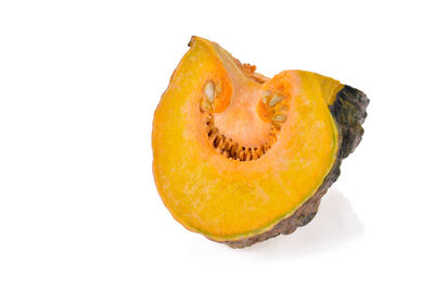 Close-up of orange slice against white background