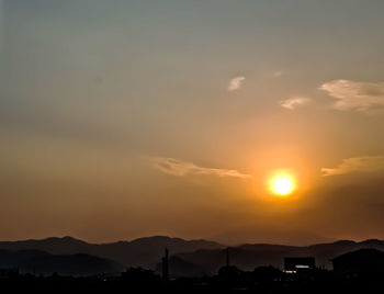 Scenic view of silhouette mountains against sky during sunset