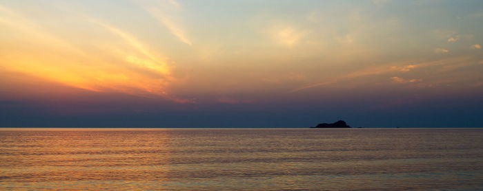 Scenic view of sea against sky at sunset