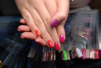 Cropped hands of woman with colorful painted nails