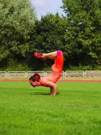 Rear view of woman fitness on field