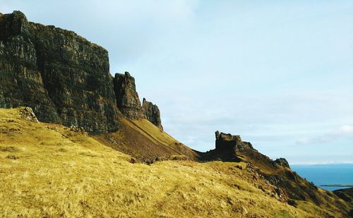 Low angle view of rock formations against sky