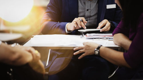 Midsection of couple holding hands on table