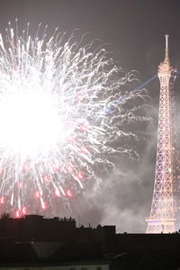 Low angle view of firework display at night