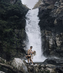 Man surfing on rock in forest