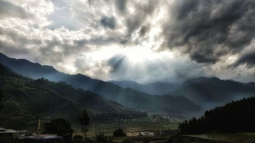 Scenic view of mountains against cloudy sky