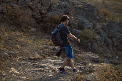 Side view of man on rock