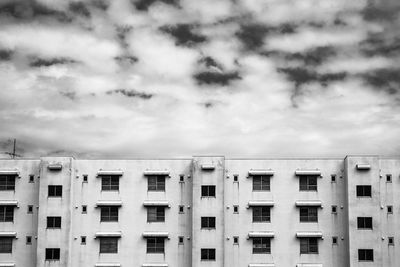 Residential building against cloudy sky