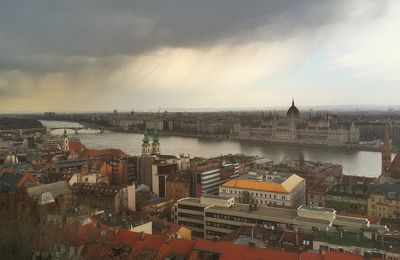 Cityscape against cloudy sky