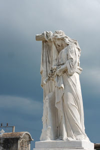 Sad woman cemetery statue in camaguey, cuba.