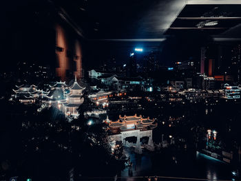 High angle view of illuminated city buildings at night