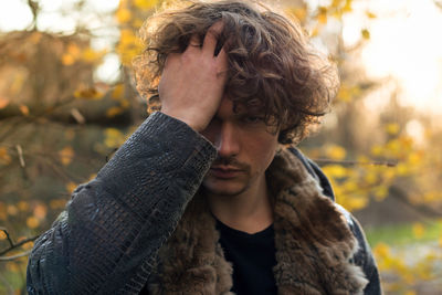 Portrait of man in warm clothes with hand in hair