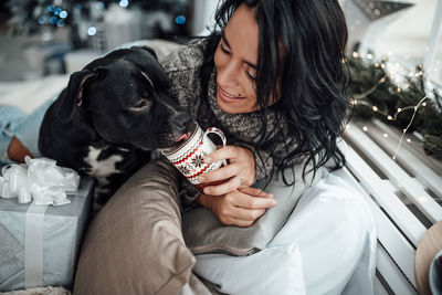 Midsection of woman holding dog