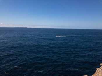 Scenic view of sea against blue sky