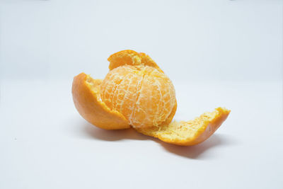 Close-up of orange slice against white background