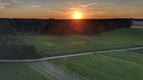 Scenic view of field against sky during sunset