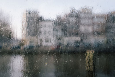 Full frame shot of wet glass window during rainy season