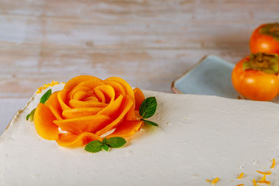 High angle view of orange rose on table