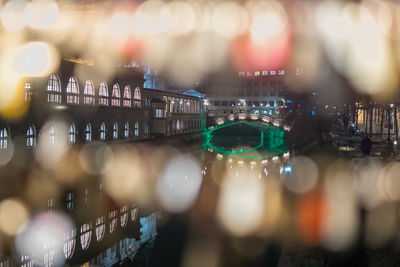 Defocused image of illuminated city at night